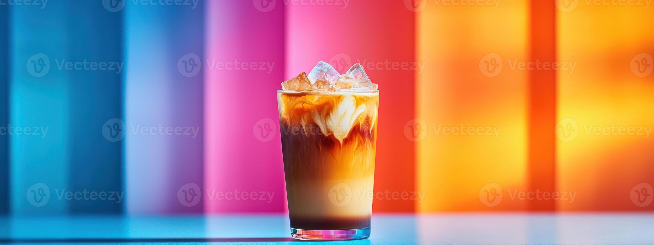 refreshing iced latte in transparent glass with layers of milk and coffee, set against vibrant, colorful background, evoking summer vibes photo