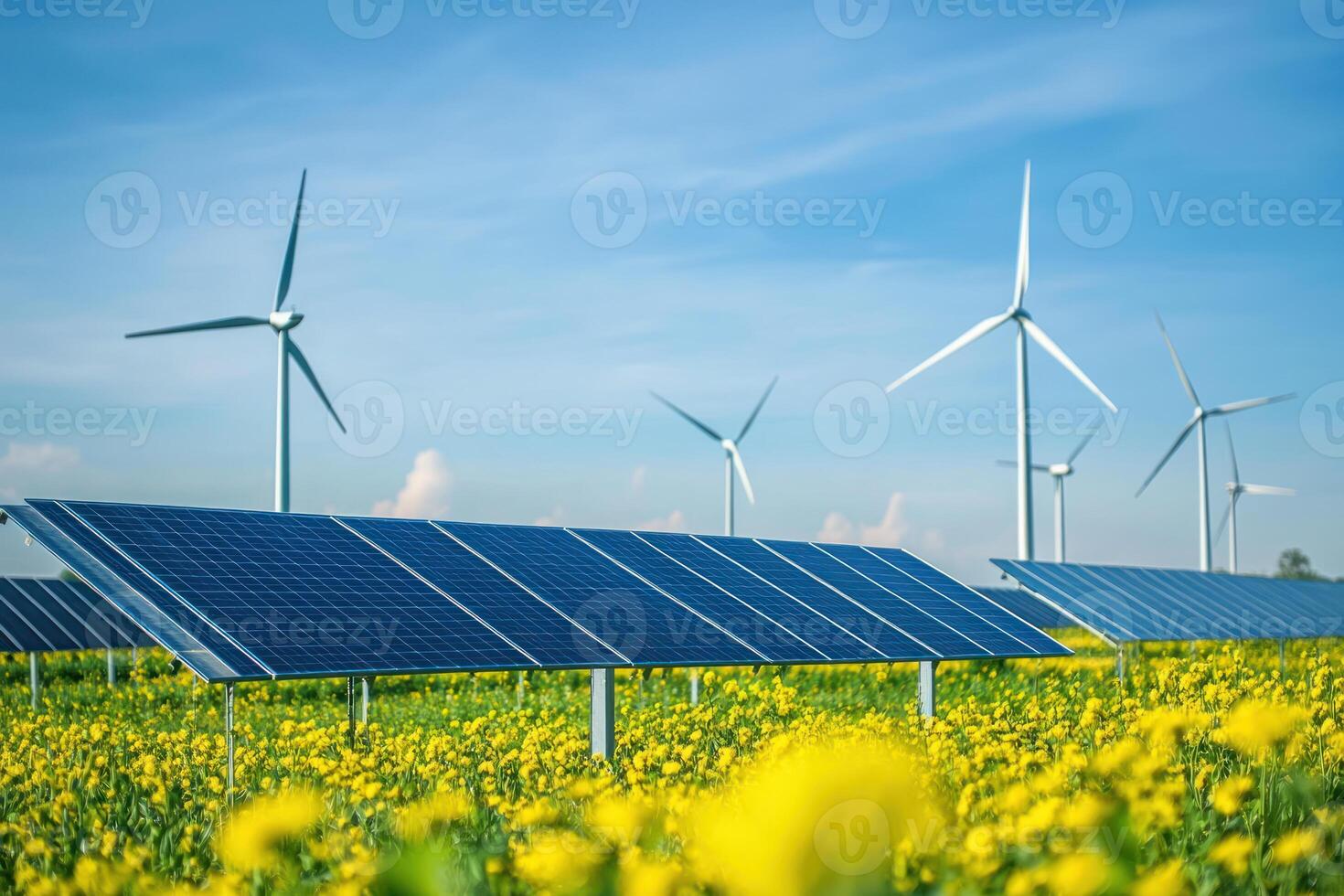 vibrant field of yellow flowers with solar panels and wind turbines showcases harmony of renewable energy sources in natural setting photo