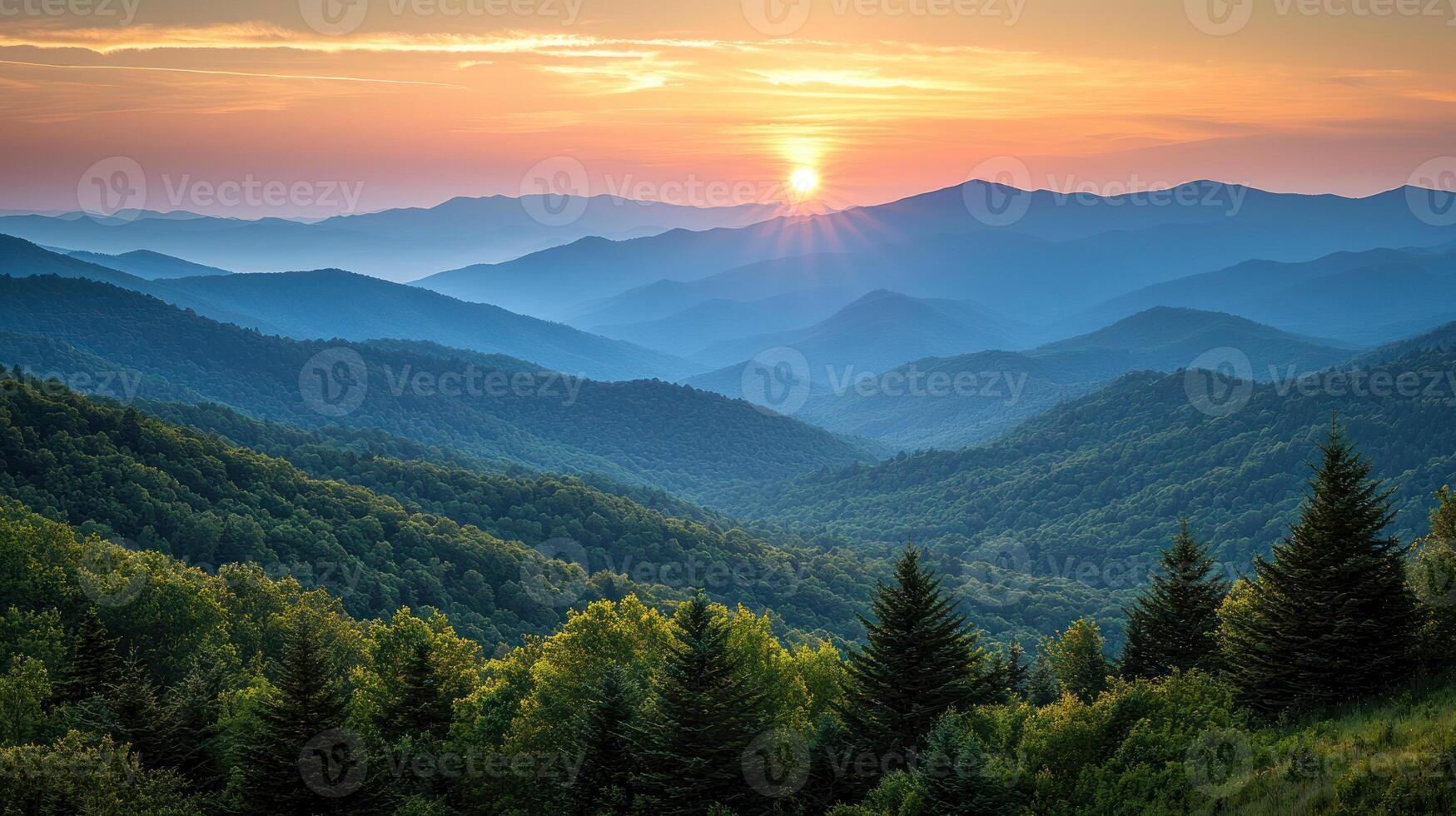 breathtaking view of evergreen forested mountains sunrise, with layers of misty blue ridges and glowing sun casting warm light over serene photo