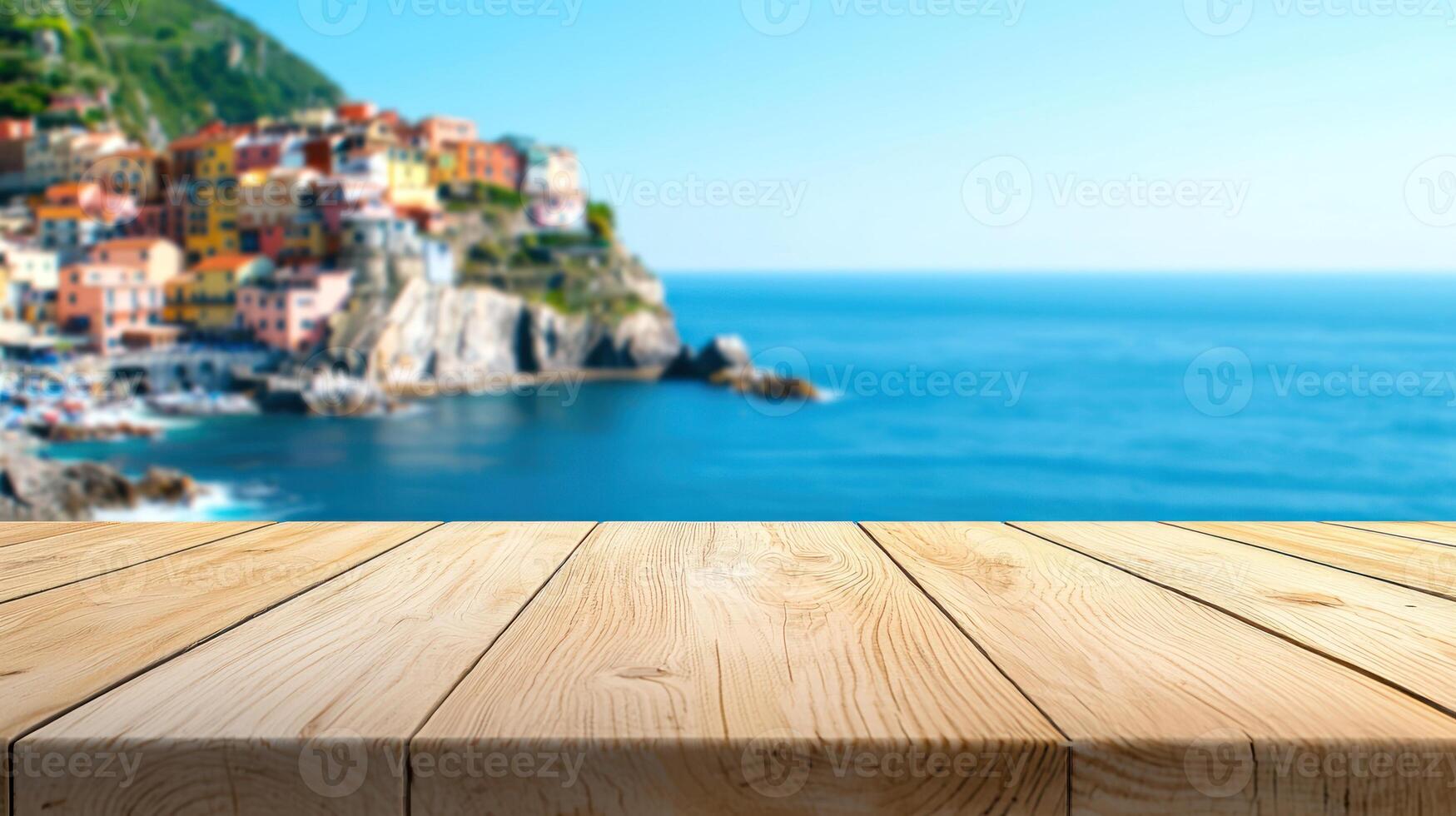 Soft toned wood table with dreamy background of cliffside coastal village, domed rooftops, and serene sea horizon photo