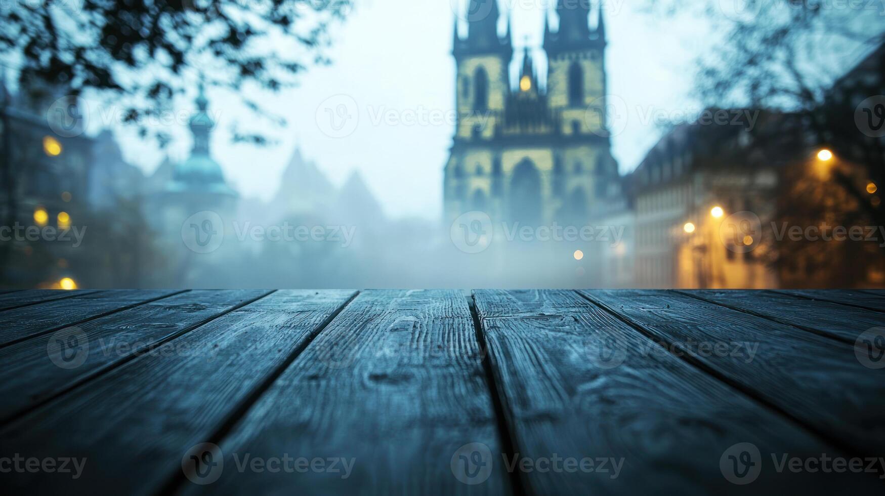 Polished dark wood table with misty blurred European cathedral fade in background, early morning fog adds mystery.. photo