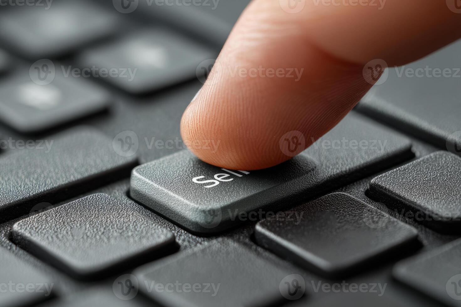 Finger pressing sell button on computer keyboard photo