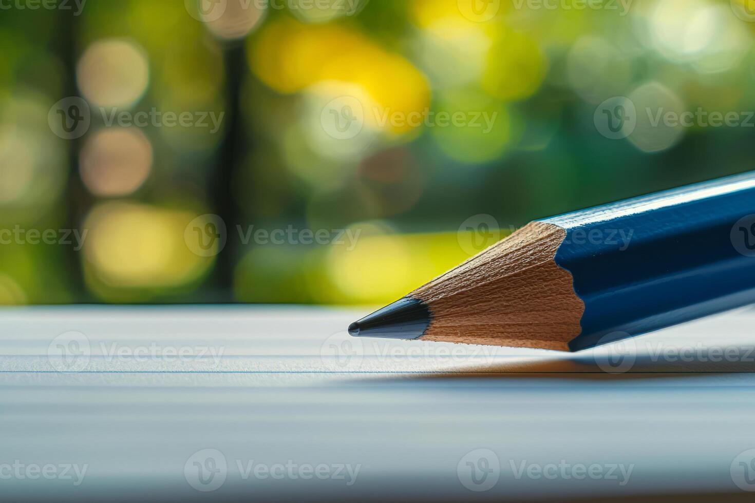 Pencil lies on a lined notebook page photo
