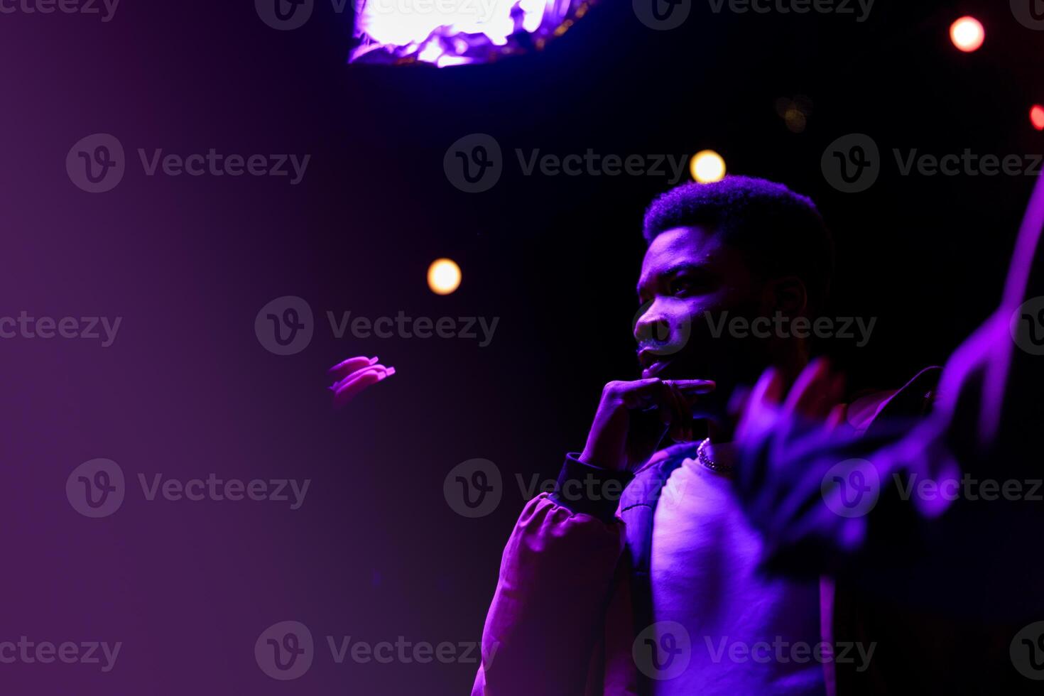 Youthful expressions during late-night music performance at local venue filled with vibrant lights photo