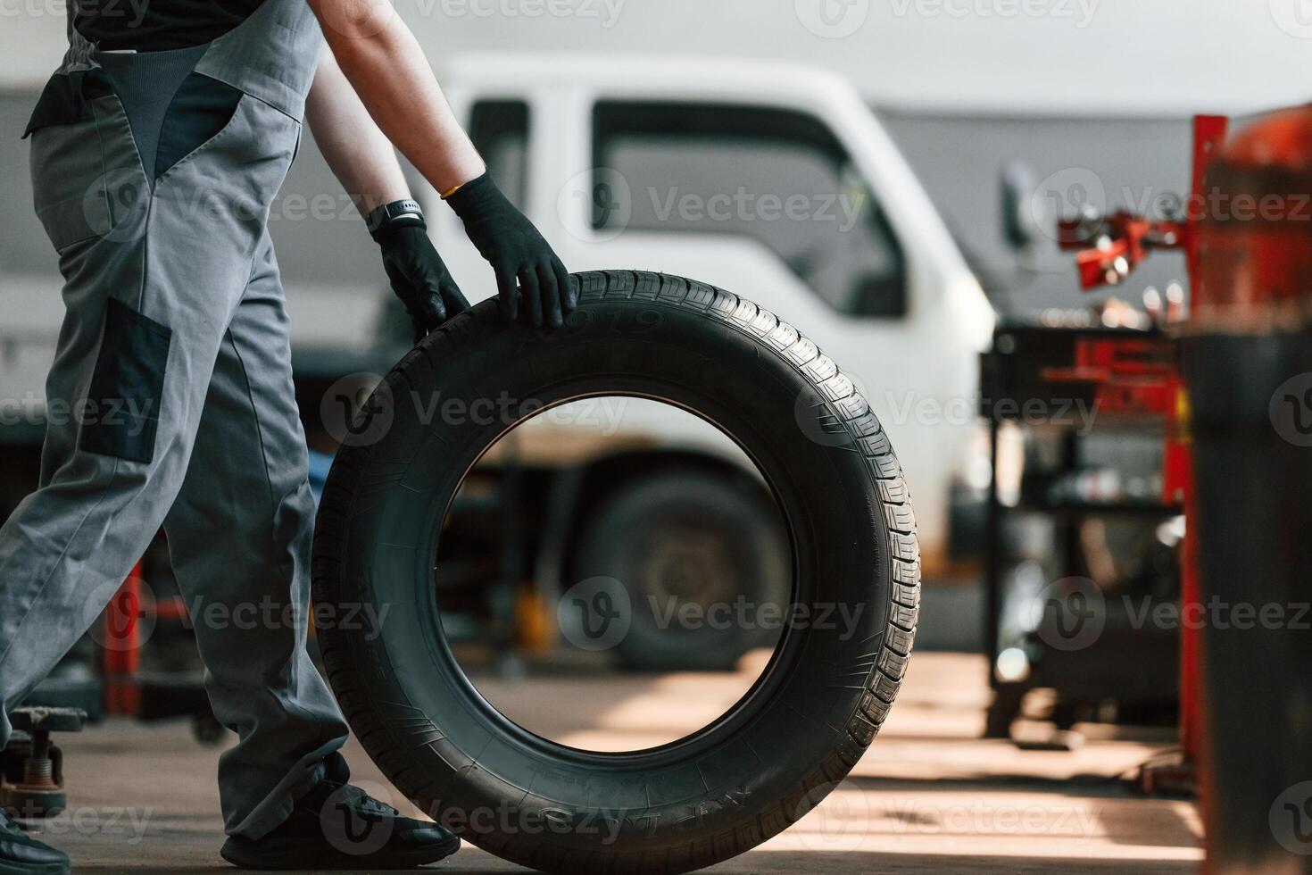 Rolling the wheel.., Man is works in the automobile repairing salon photo