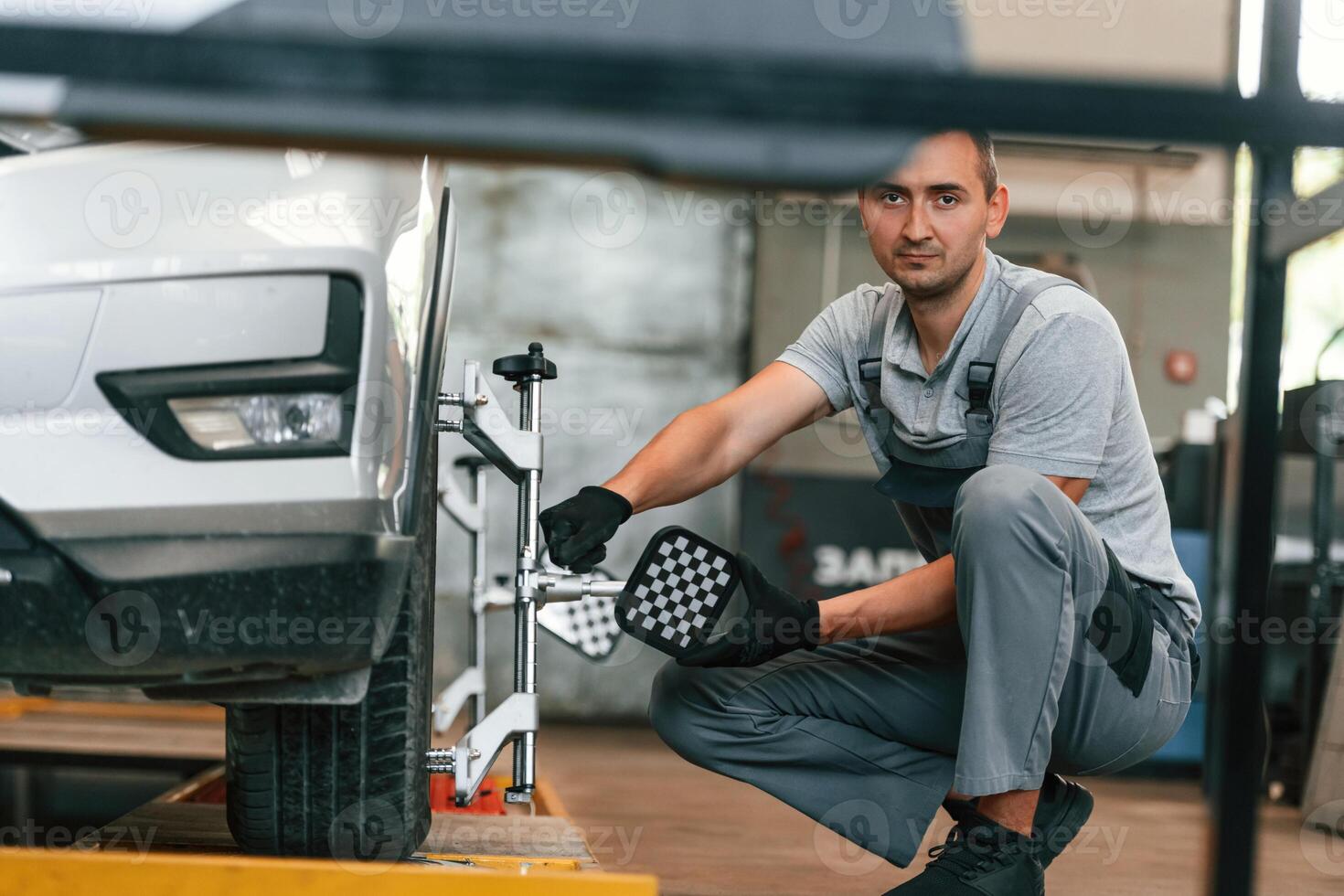 Wheel changing. Man is works in the automobile repairing salon photo