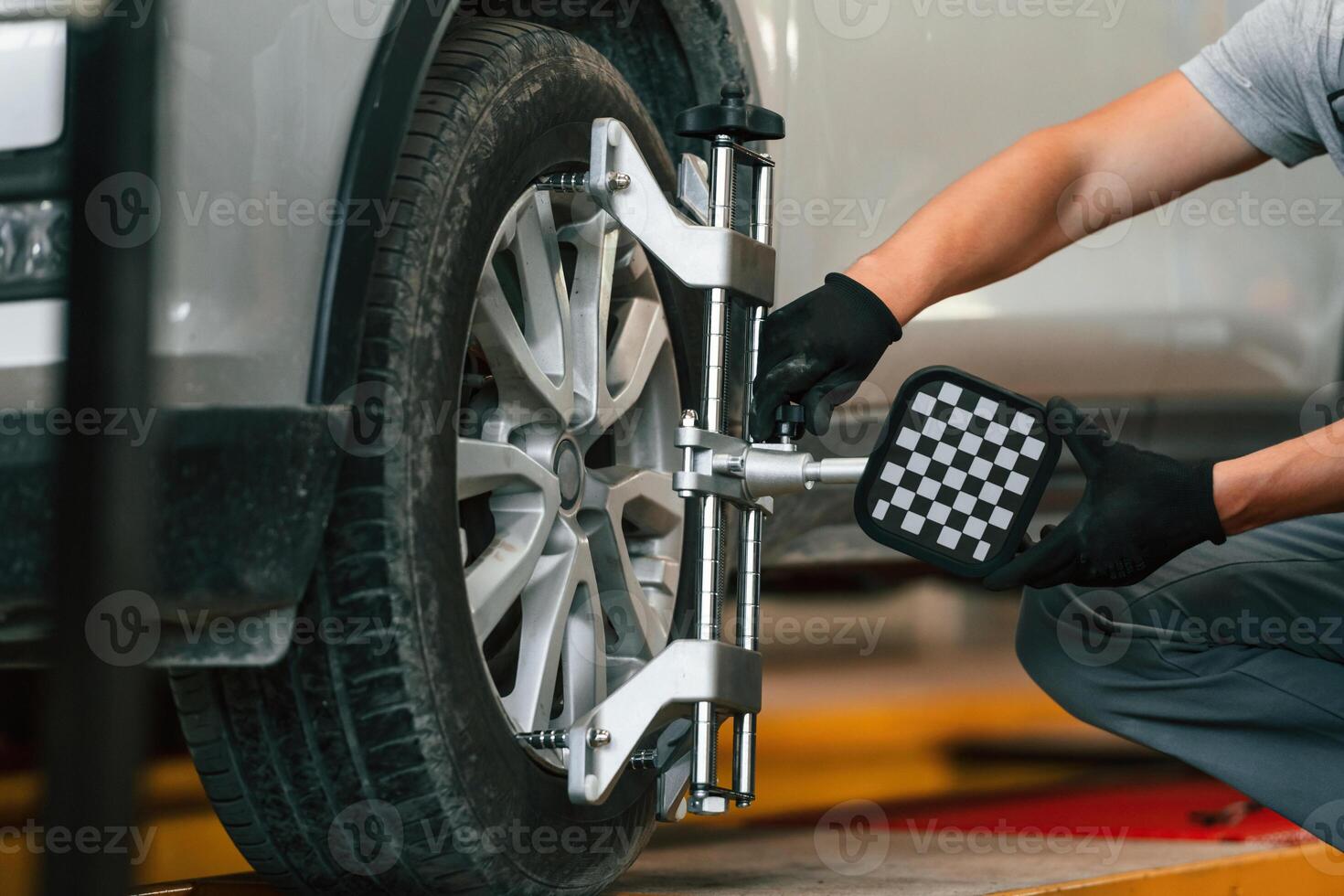 Adjusting the tire,. Man, is works in the automobile repairing salon photo