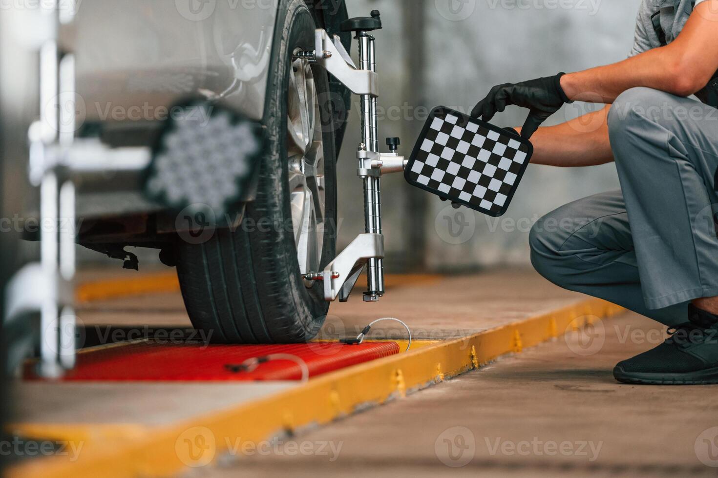 Wheel changing. Man ,is works in the automobile repairing salon photo