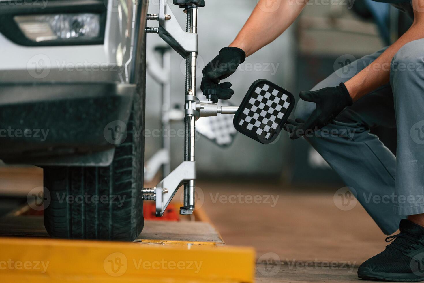 Wheel changing. Man is works, in the automobile repairing salon photo