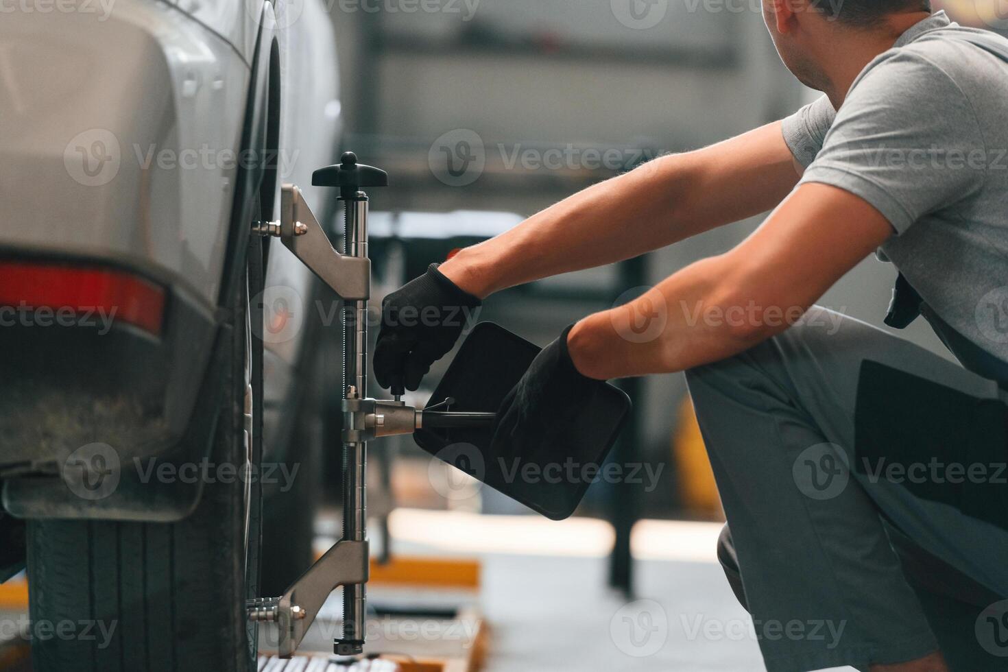 Changing, the, tire. Man is works in the automobile repairing salon photo