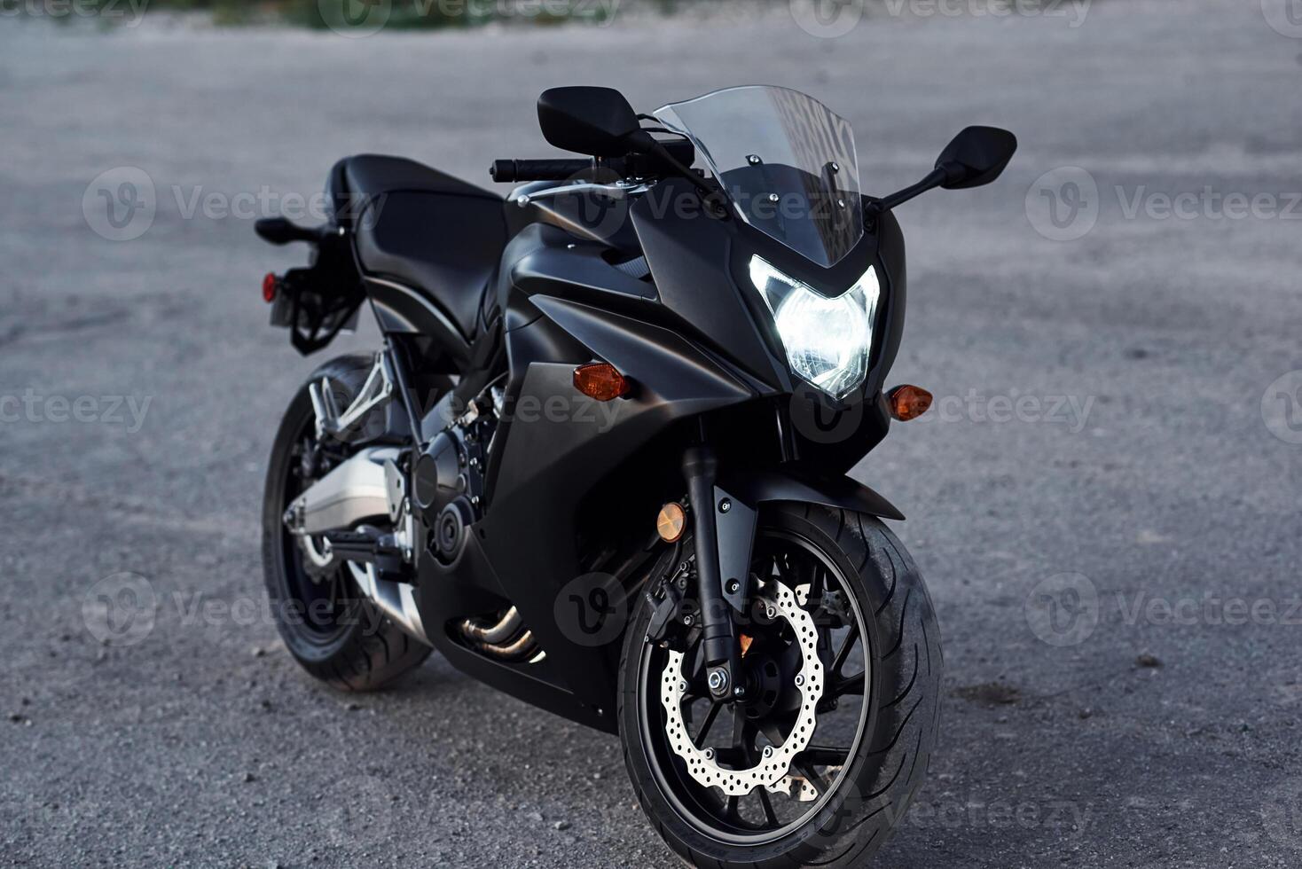 Black colored vehicle., Close ,up view of modern motorcycle that is parked outdoors photo