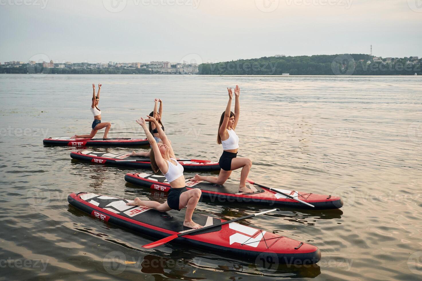 In the, lake. Young women are on sup boards photo