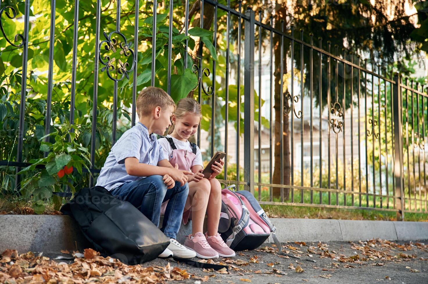 Young ,school,, children of boy and girl are together outdoors photo