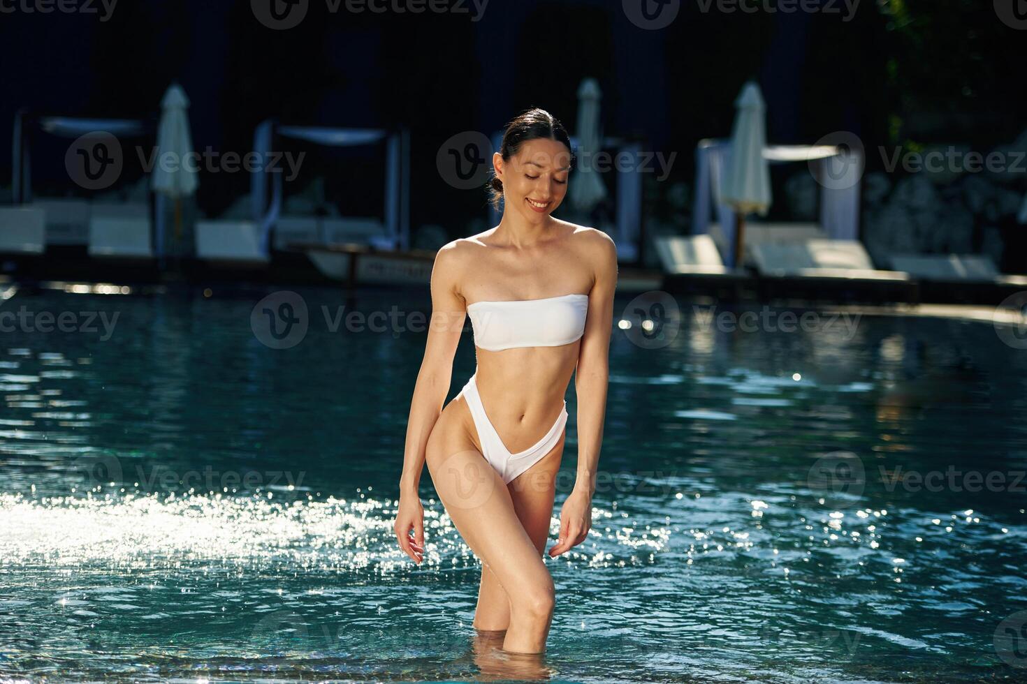 Fresh water,, standing. Woman in white underwear is in the pool photo