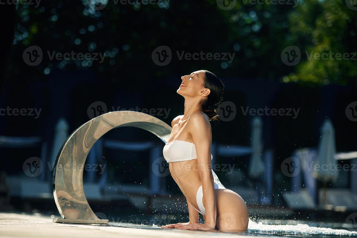 Conception, of resort and relax. Woman in white underwear is in the pool photo