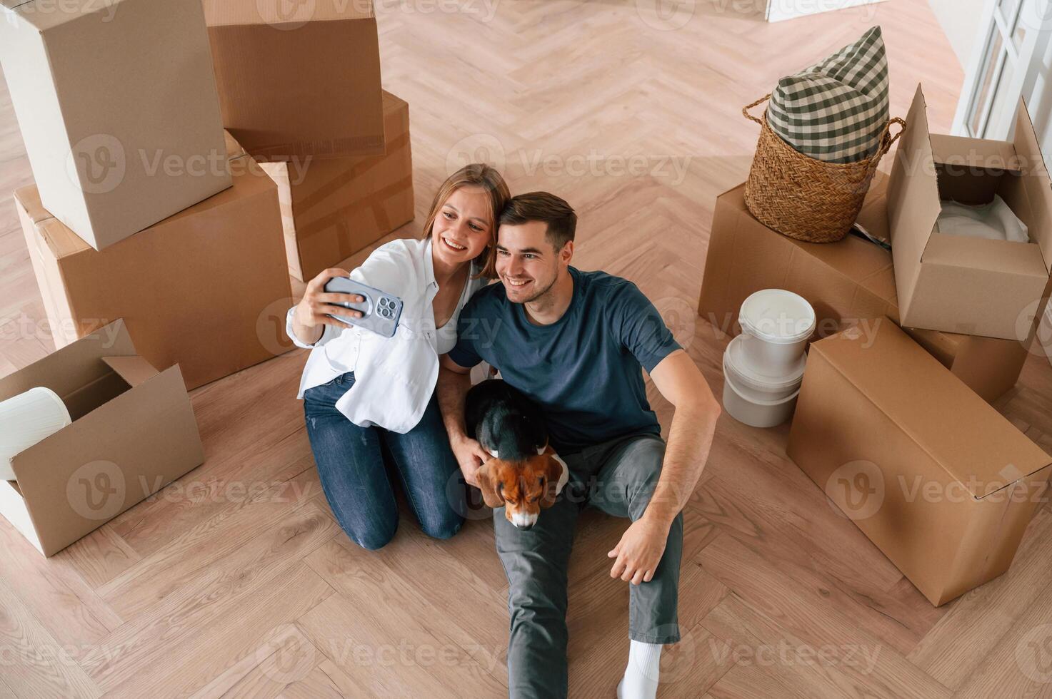 Looking at ,appartment.. Young couple with dog are moving to new home photo