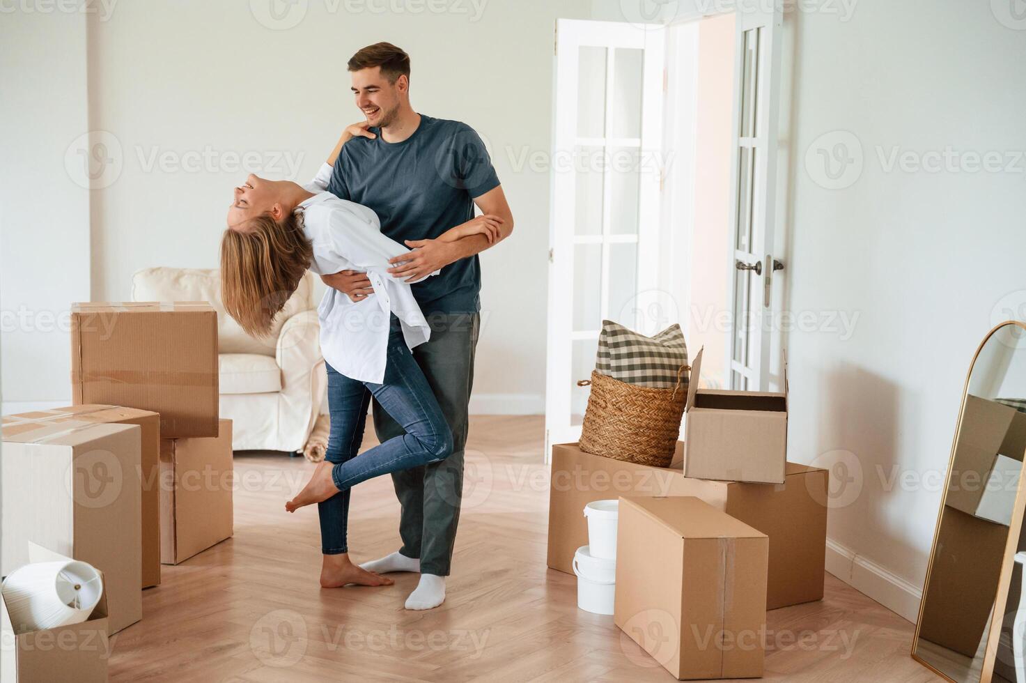 Dancing, celebrating. Young, couple, moving to new home photo