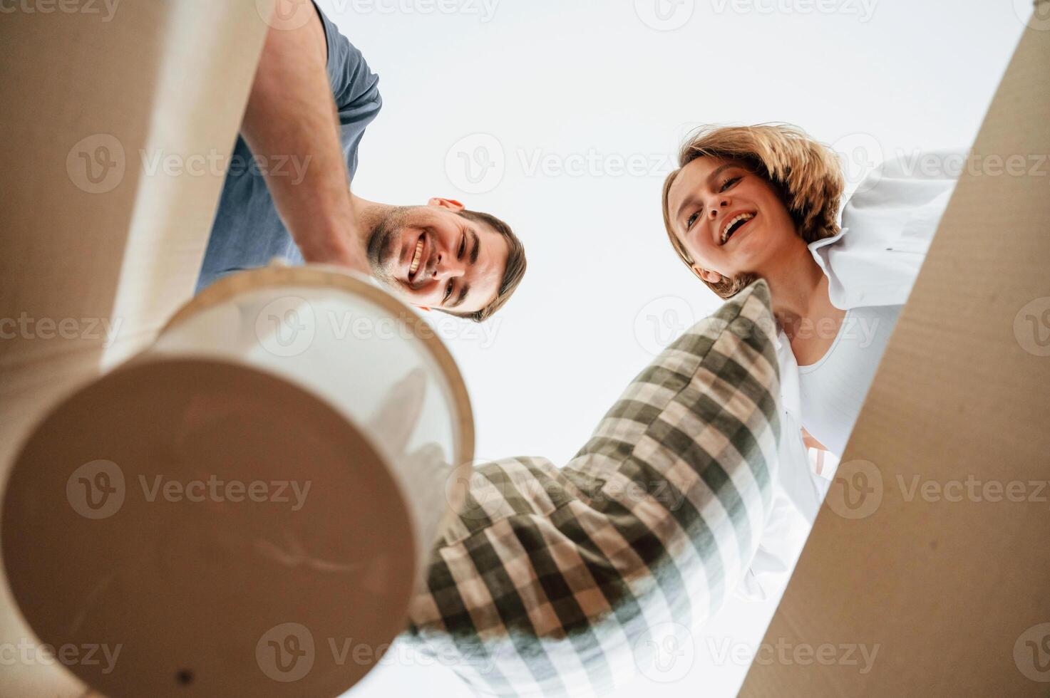 View, from the inside of a box. Young couple moving to new home photo