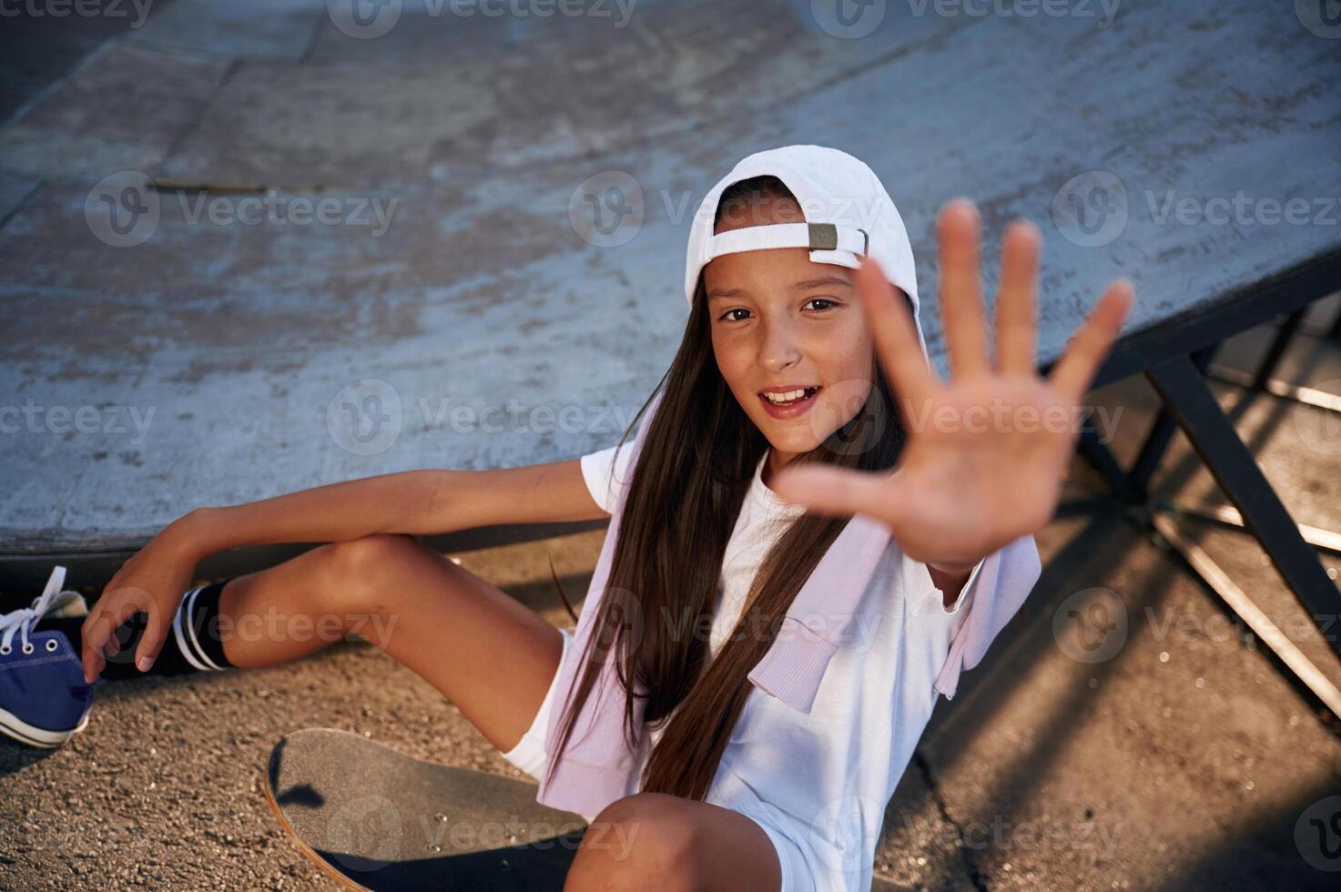 Giving, the, high five. Happy little girl with skateboard outdoors photo