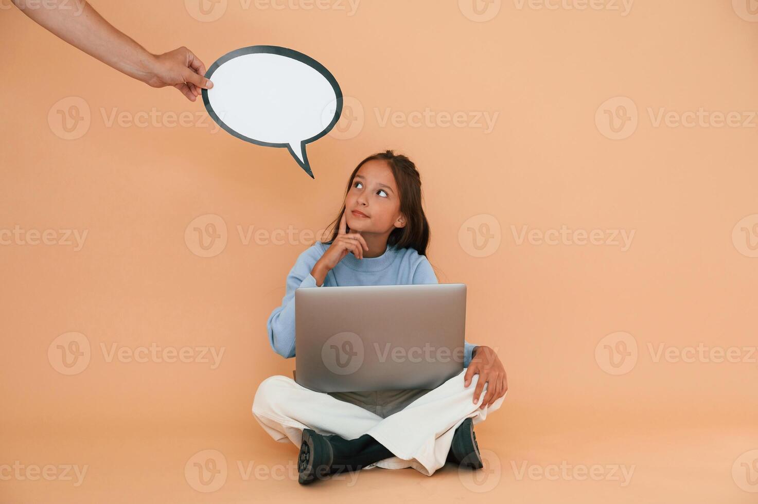 Hand is, holding ,sticker with copy space for text, thoughts. Sitting with laptop. Cute young girl photo