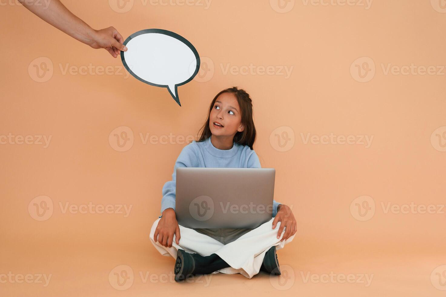 Hand, is holding, sticker with copy space for text, thoughts. Sitting with laptop. Cute young girl photo