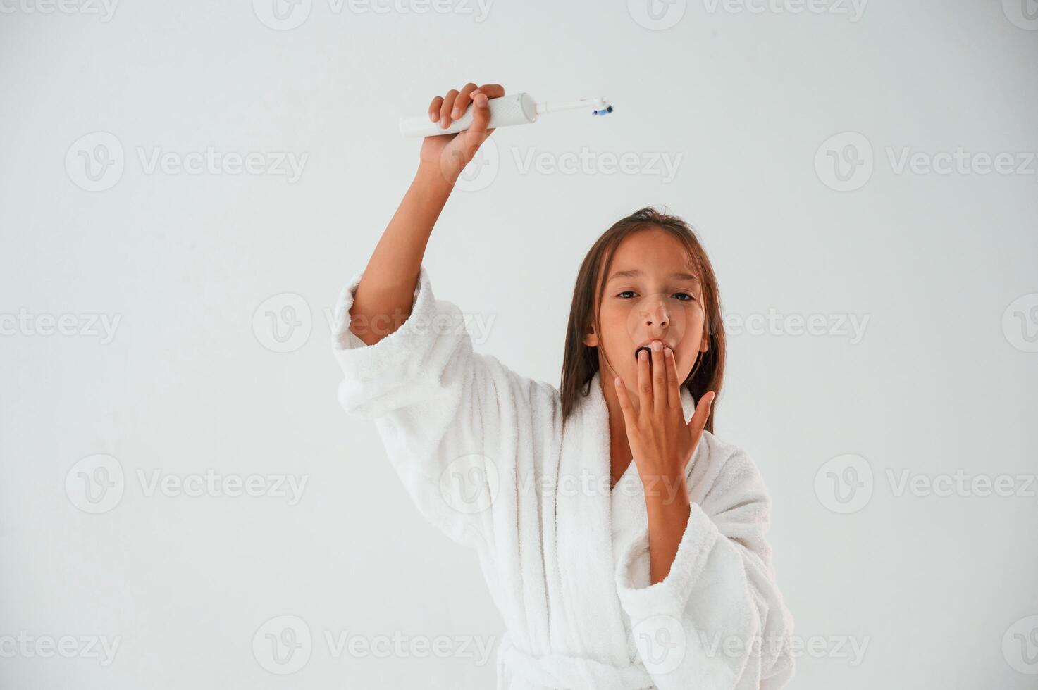 Toothbrush ,in, hand. Conception of beauty and self care. Young girl is in the studio photo