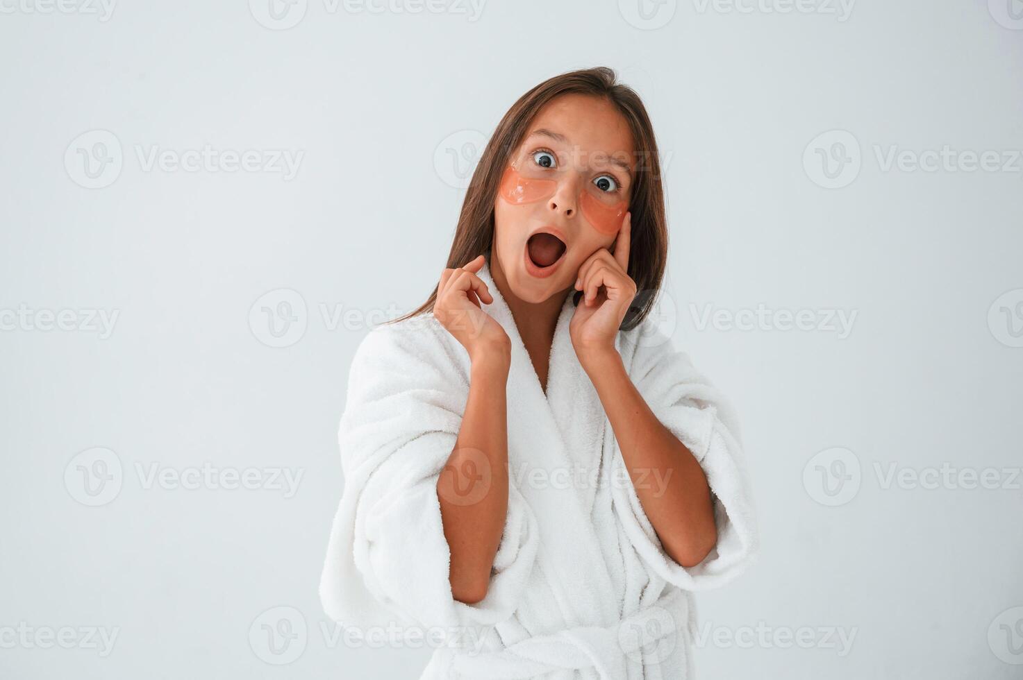 Positive, and, surprised facial expression. With eye patches. Conception of beauty. Young girl is in the studio photo