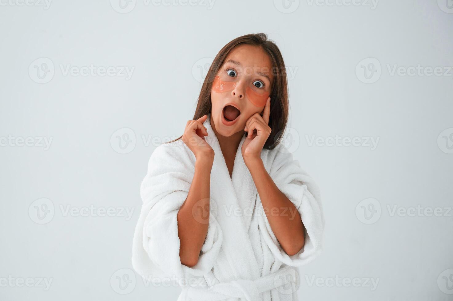 Positive and surprised facial, expression.. With eye patches. Conception of beauty. Young girl is in the studio photo