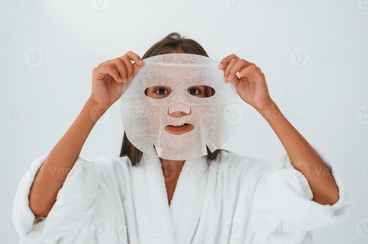 Wearing off mask for the ,face. Conception of beauty and self care. Young girl is in the studio photo