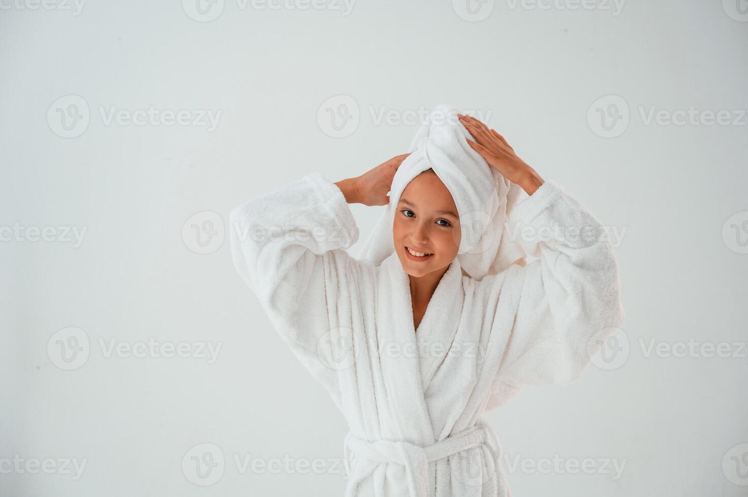 With towel ,on, the head. Conception of beauty and self care. Young girl is in the studio photo