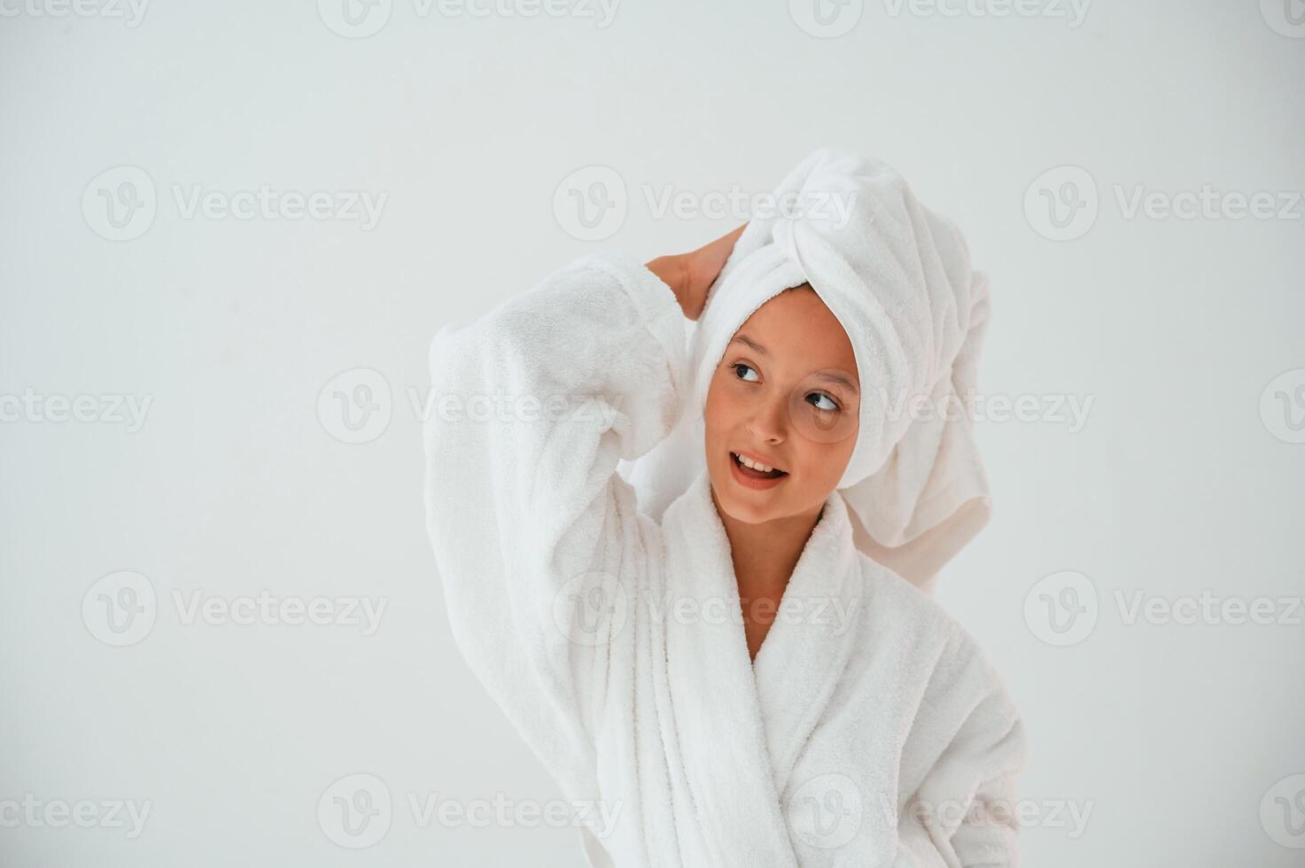 With,, towel on the head. Conception of beauty and self care. Young girl is in the studio photo