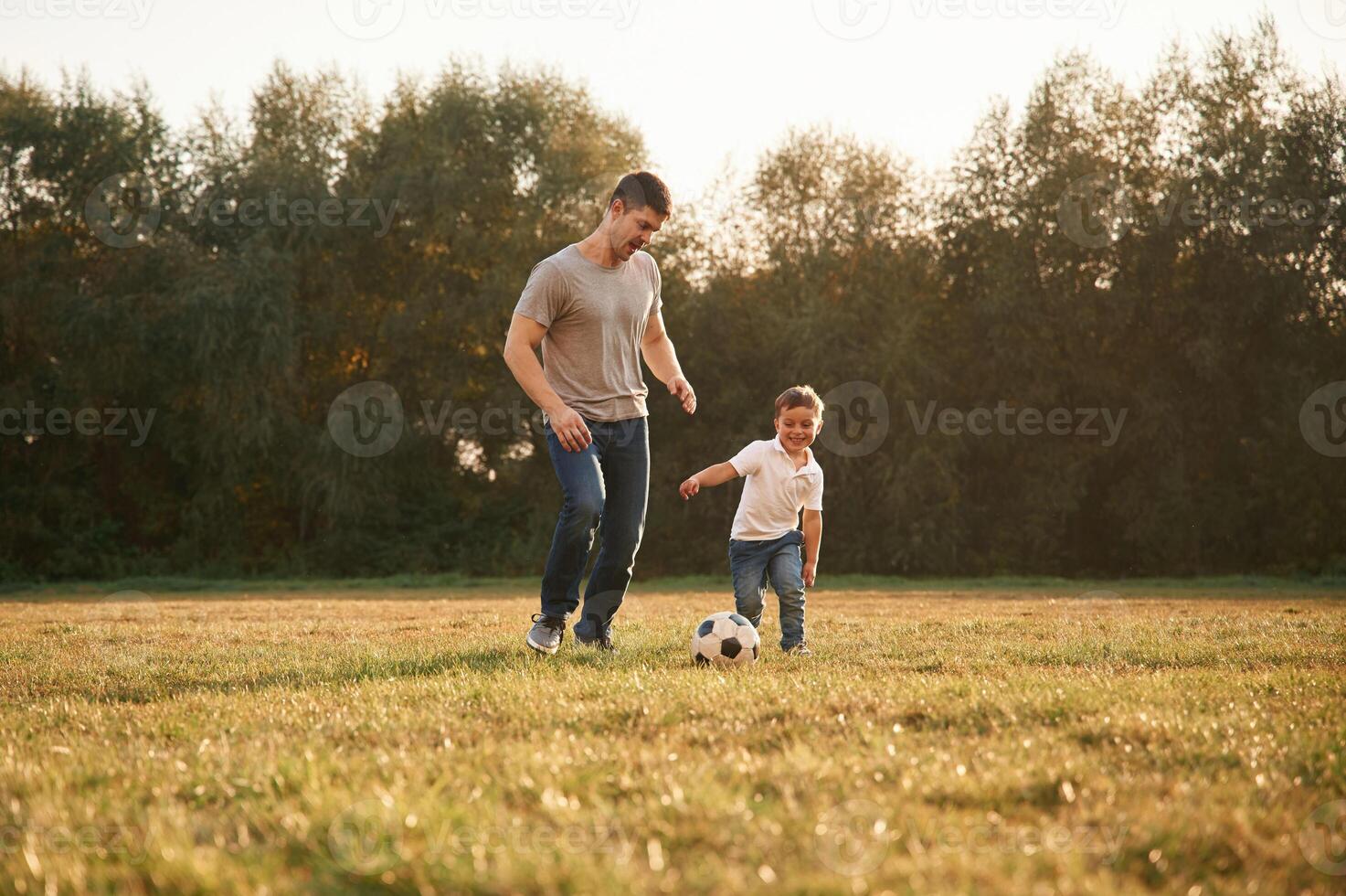 Conception of soccer ,,game. Father and little son are playing and having fun outdoors photo