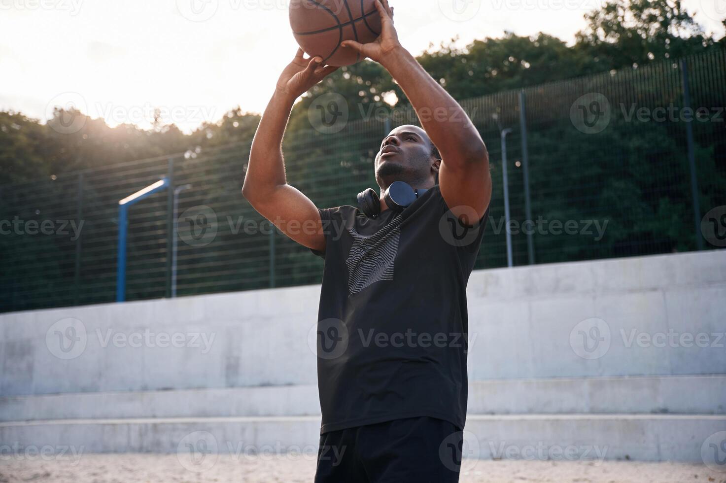 Natural, lighting. Young black man is with basketball ball outdoors photo