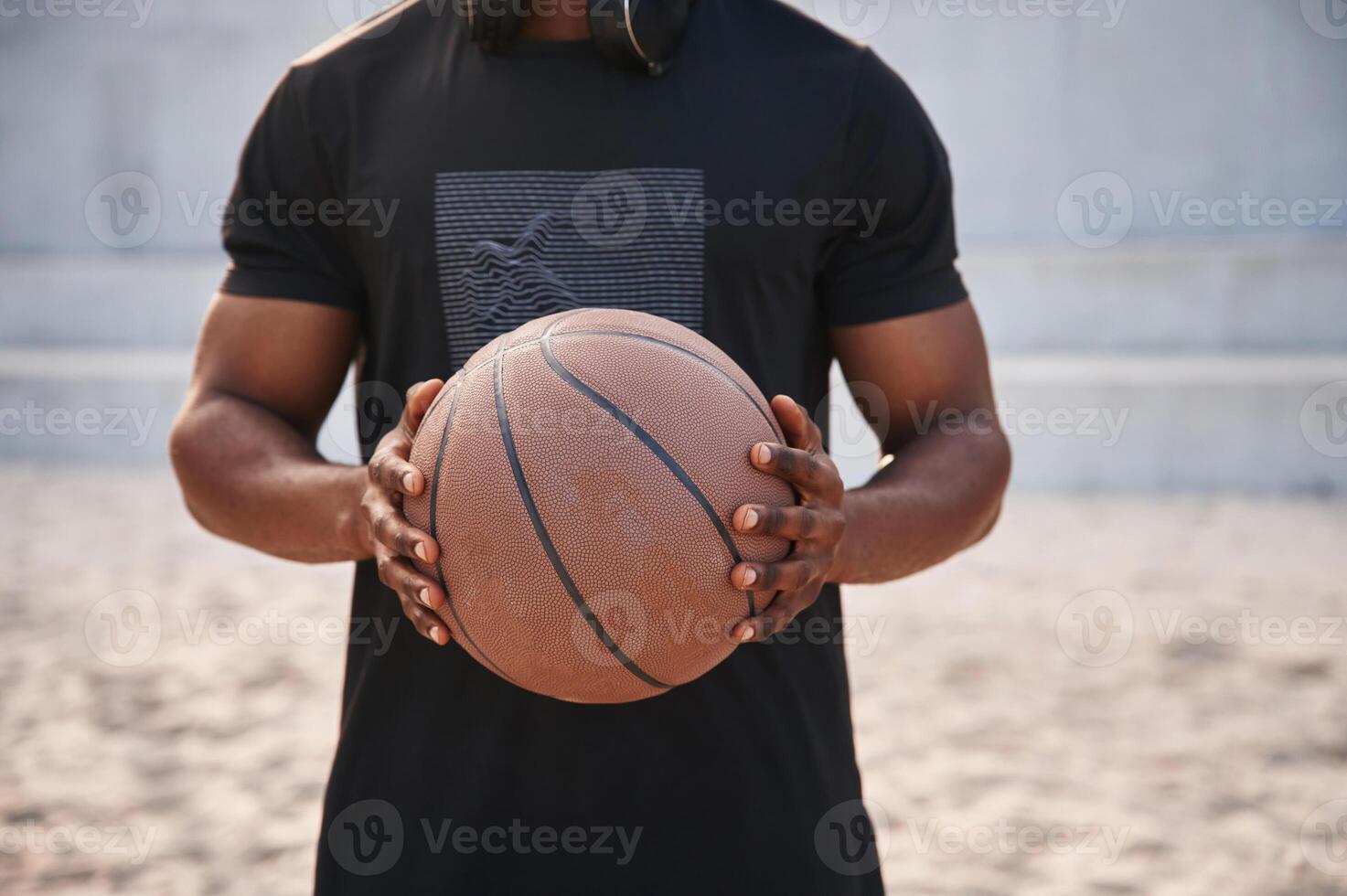 Close up view. Young black man, is with ,basketball ball outdoors photo