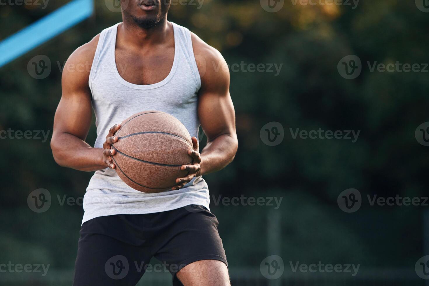 Front ,view.. Young black man ,is with basketball ball outdoors photo