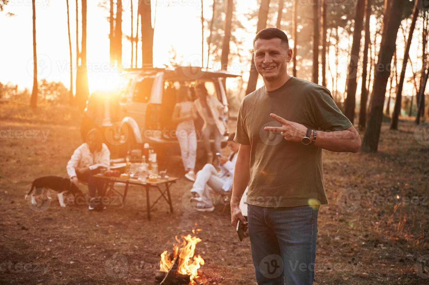 Happy, man ,is smiling. Group of friends are together in the forest photo