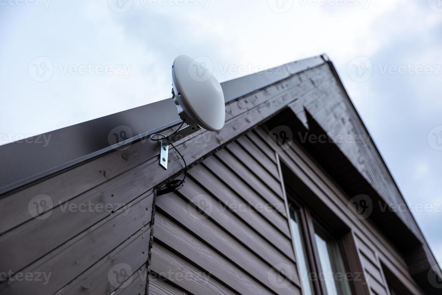 Modern Private House with Wooden Siding and Anthena Wi Fi Router photo