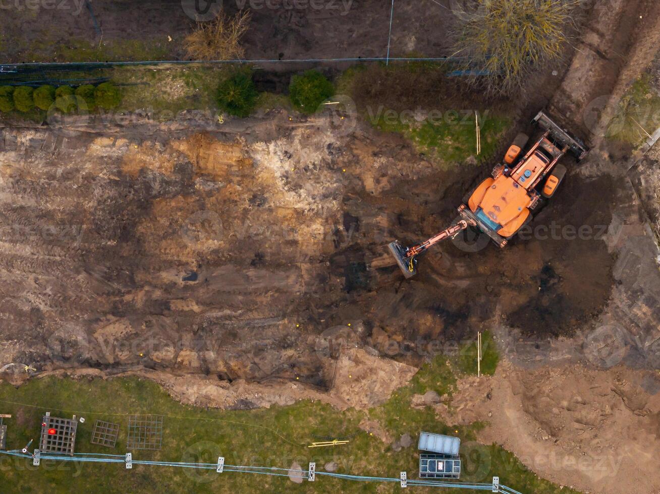 Aerial View of Excavator at Construction Site with Soil Excavation photo