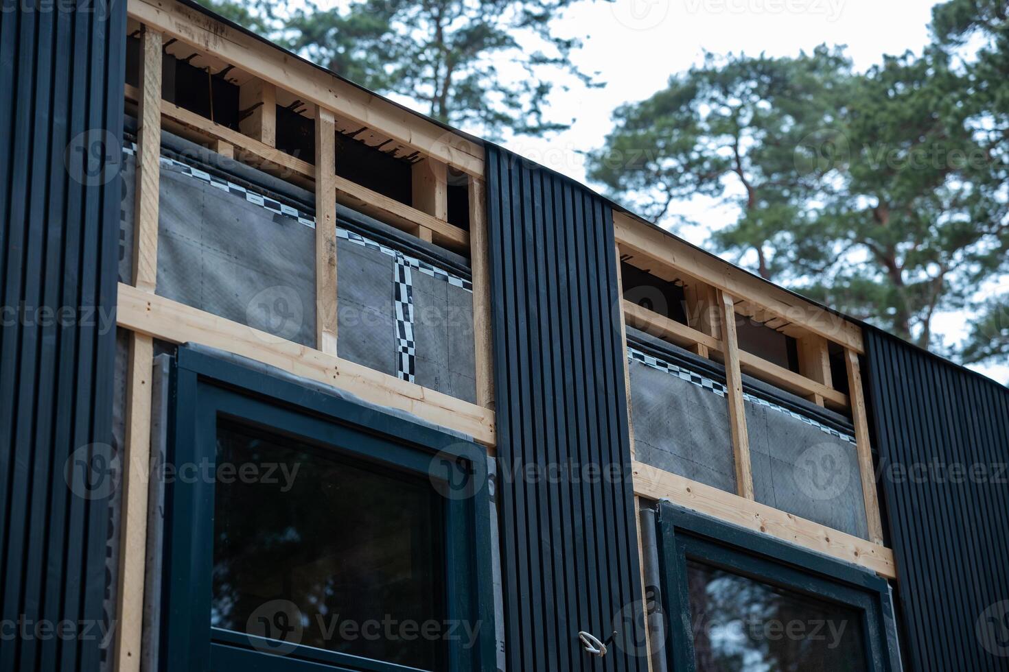 House Under Construction with Vertical Cladding and Ventilation System photo