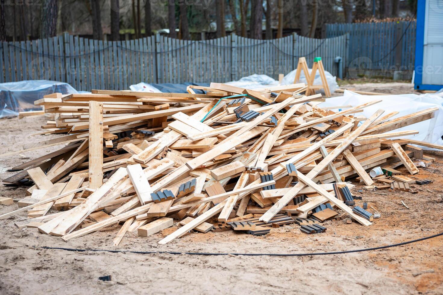 Construction Site with Wooden Planks and Blue Temporary Structure photo