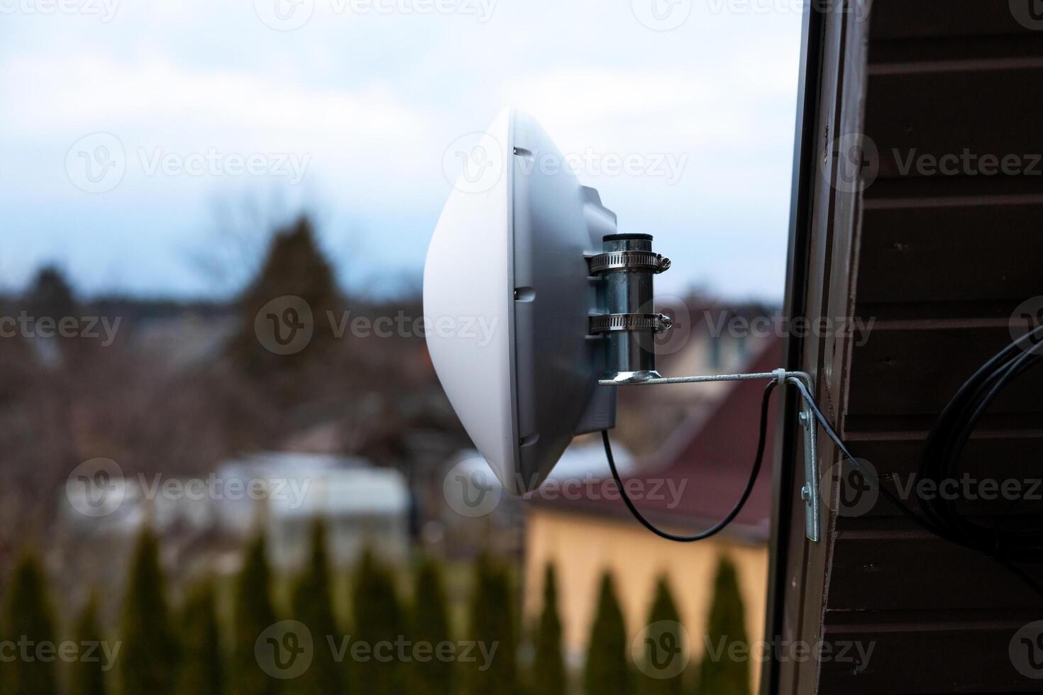 Mounted White WiFi Router on House Wall with Suburban Background photo