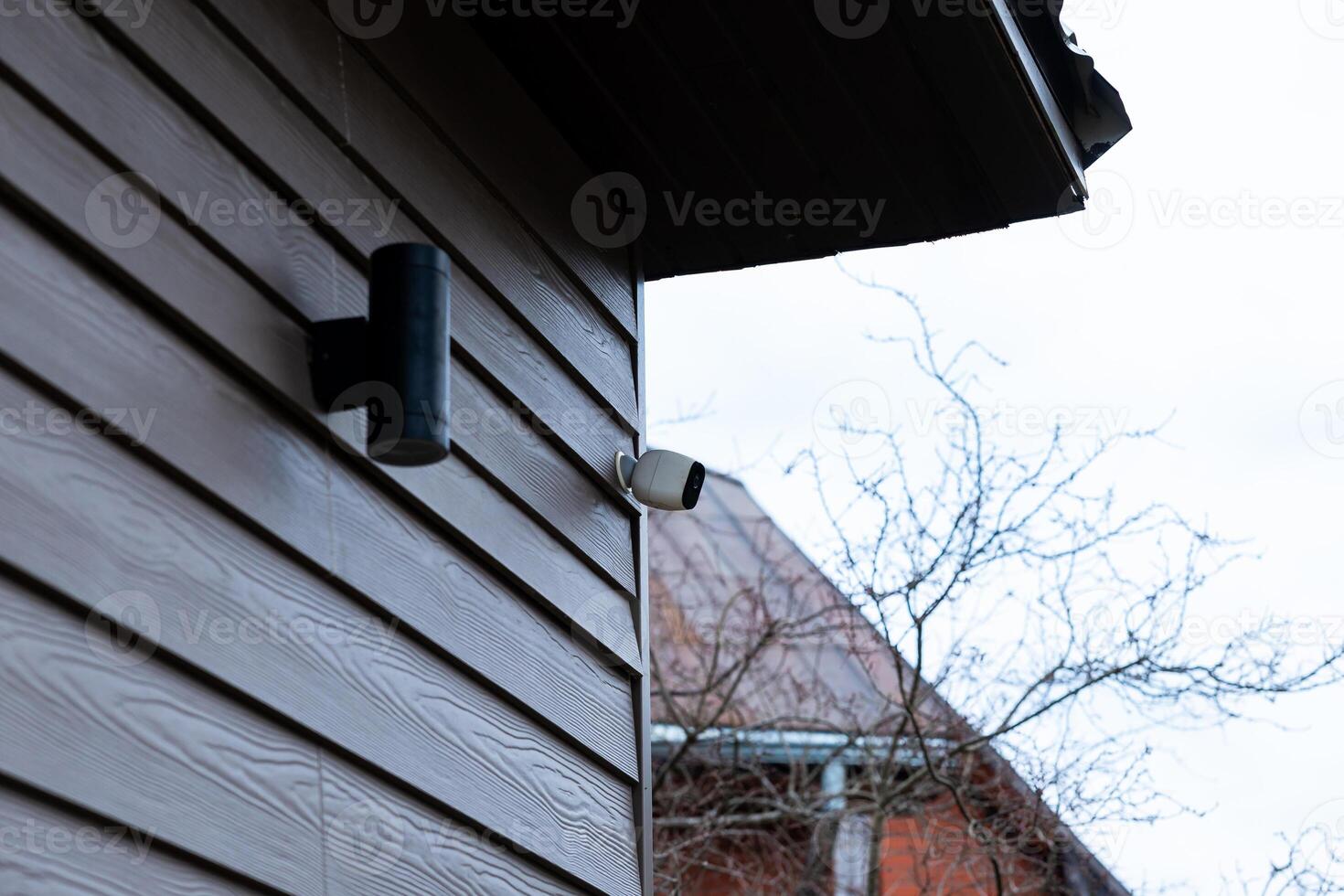 Corner of Private House with Wooden Siding and Security Camera photo
