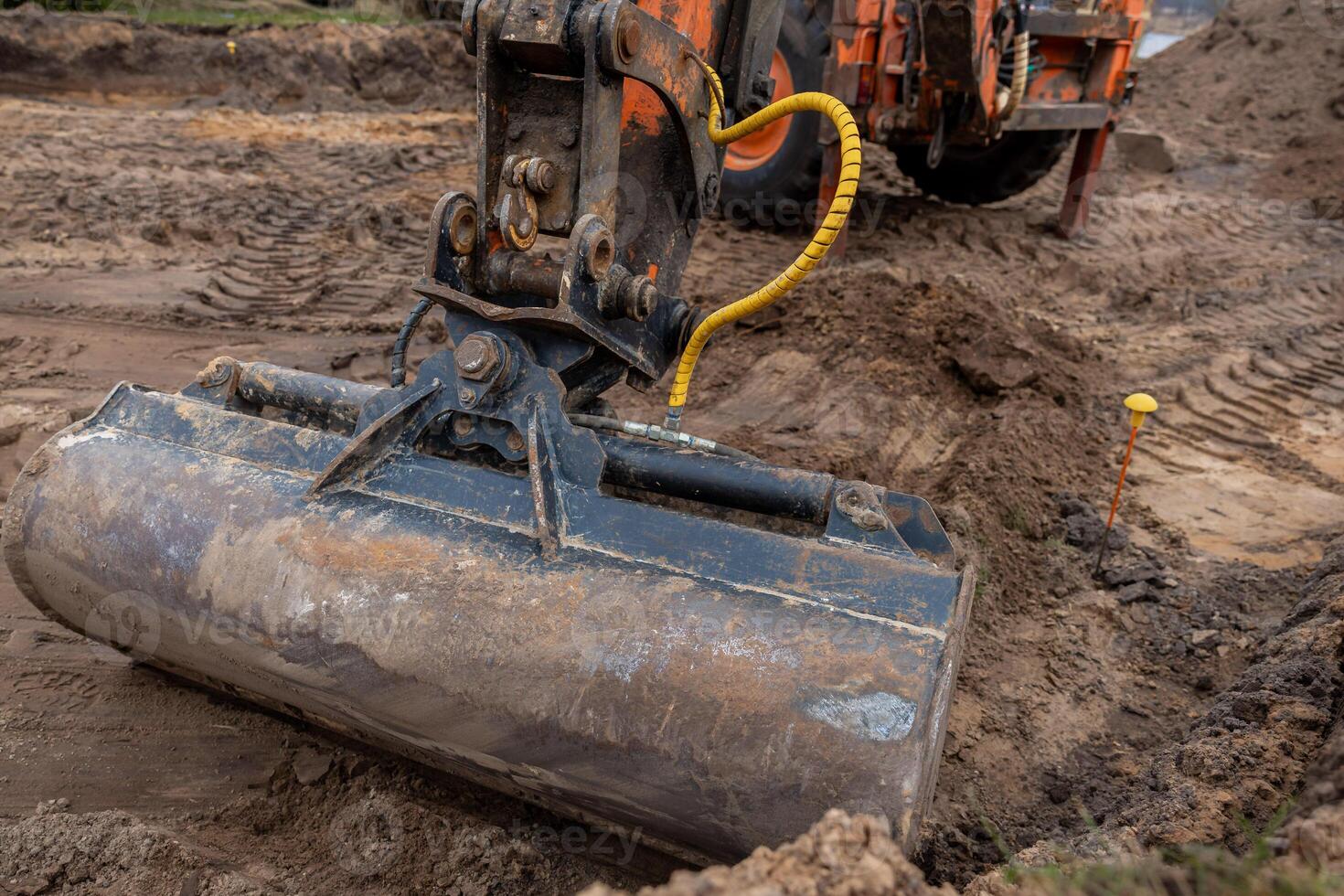 Excavator Bucket in Action on Active Construction Site photo