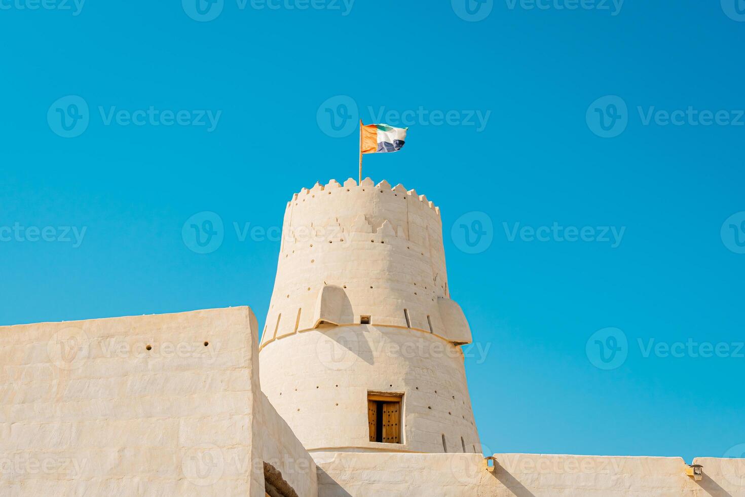 A large building with a flag flying on top photo