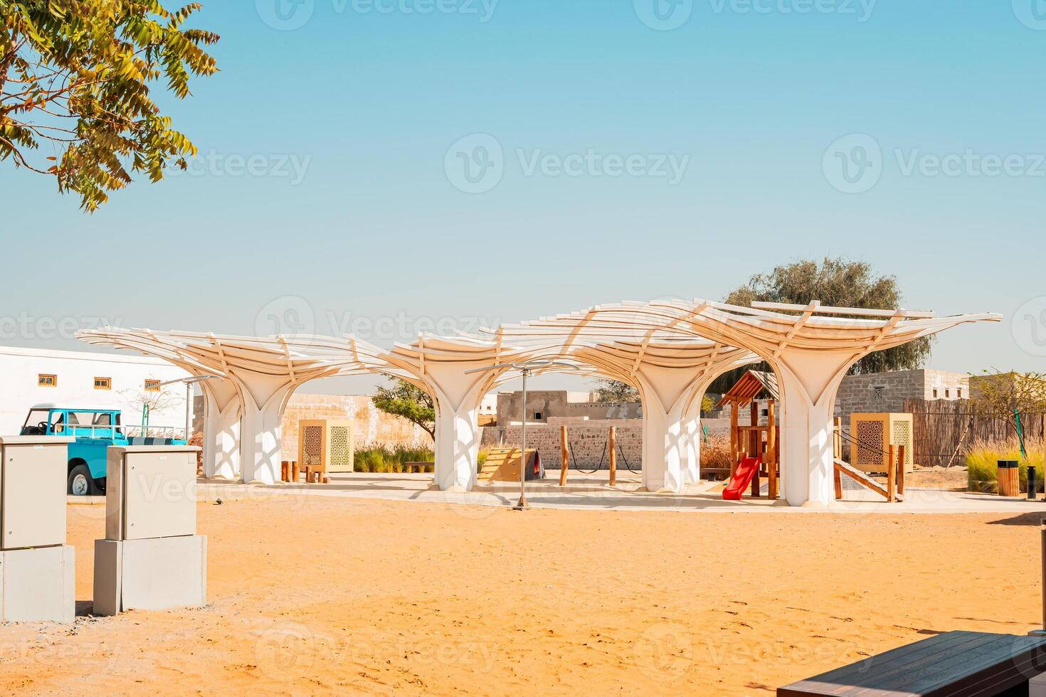 A playground with a structure made of white fabric photo