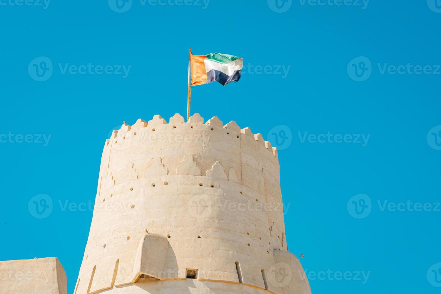 A large tower with a flag flying on top photo