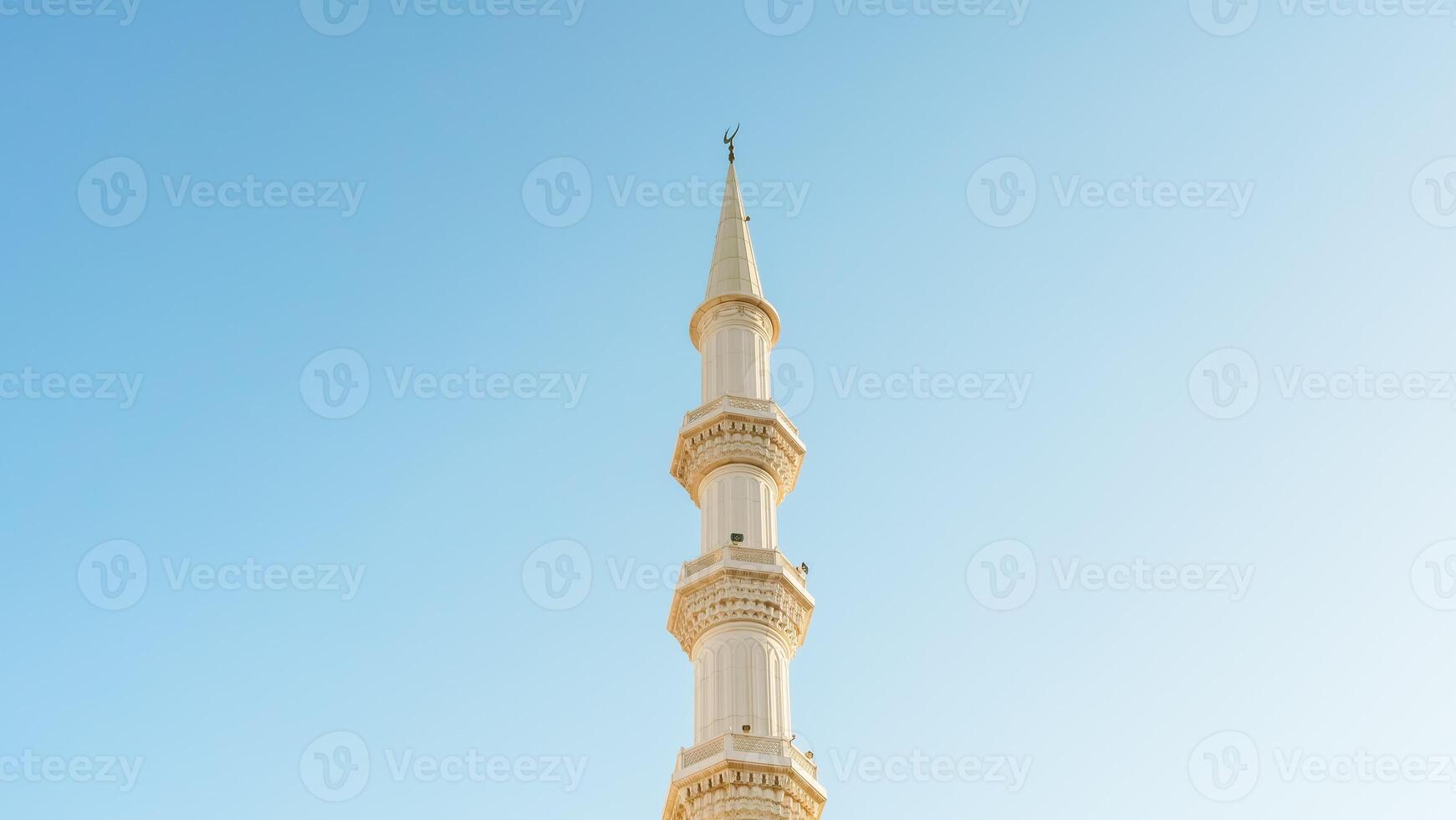 A tall white tower with a clock on top photo