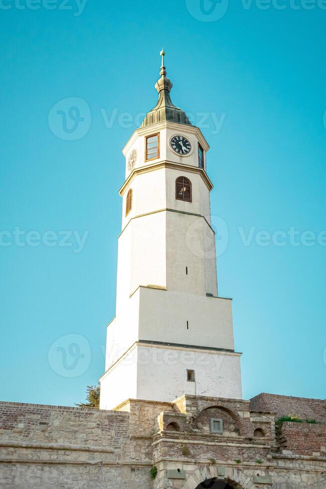 A white tower with a clock photo