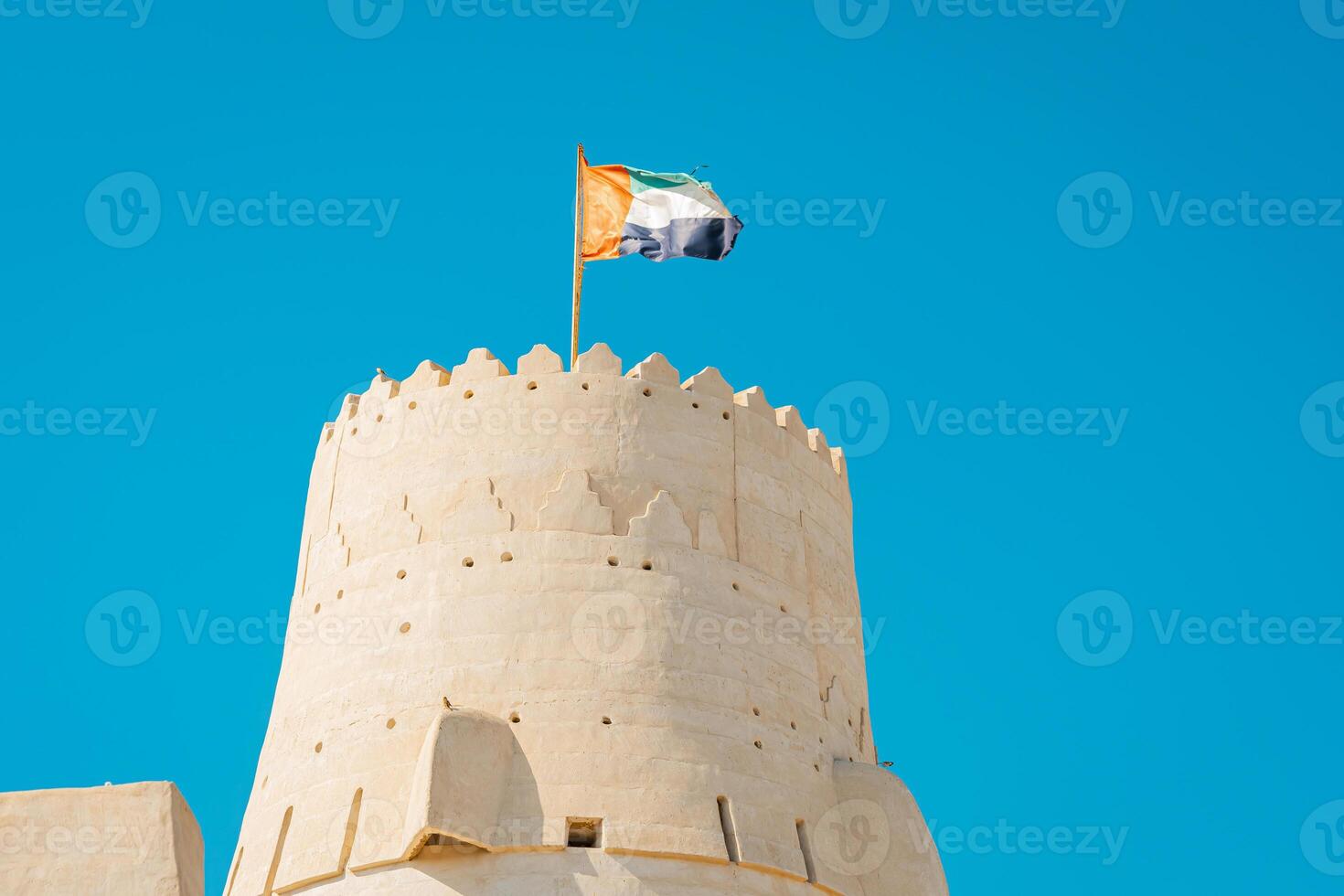 A large tower with a flag flying in the air photo