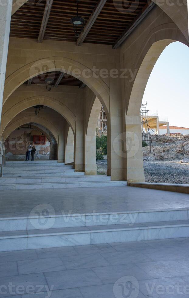 Exploring beautiful stone arches beneath a historic building in the quiet afternoon light. photo